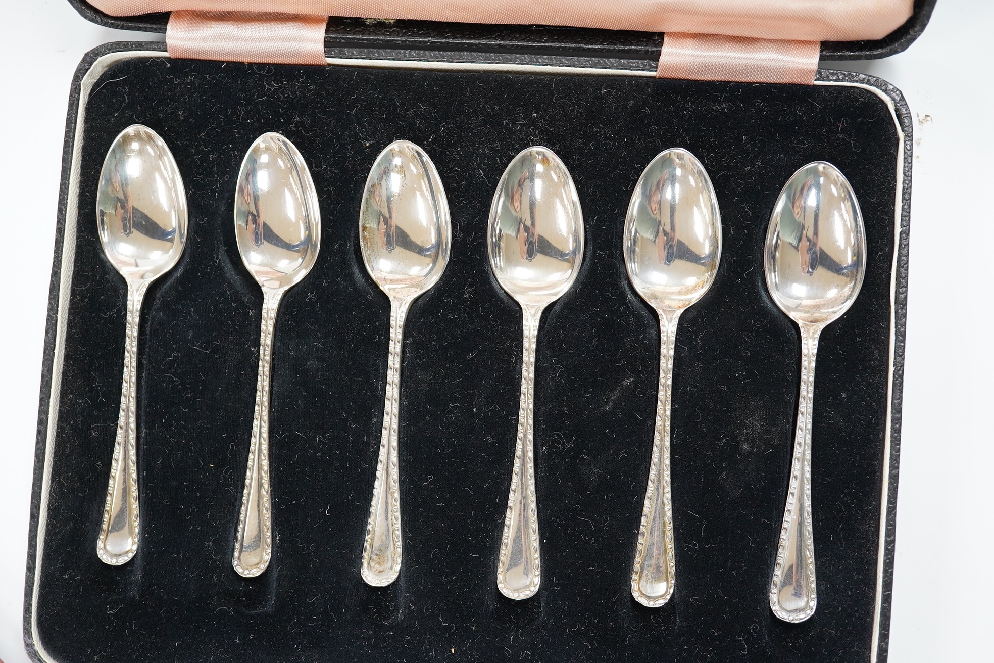 Two cased sets of six silver teaspoons, including enamelled. Condition - poor and good